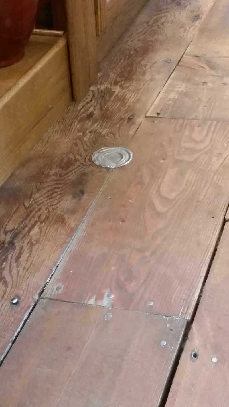 Yup, that’s a soup can lid patching a hole in a floor in one of the businesses.